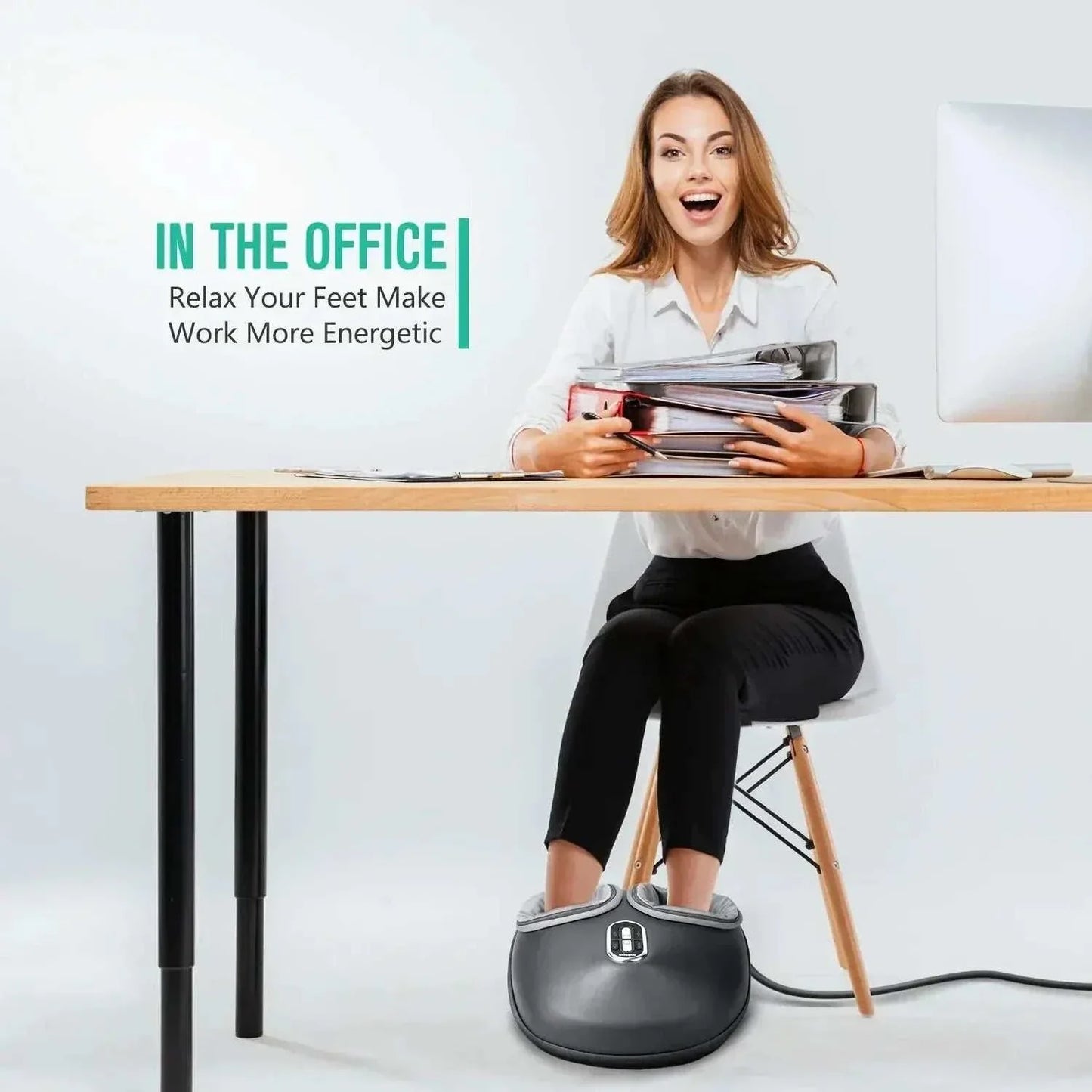 Woman using Shiatsu Foot Massager with heat and air compression under office desk for foot relaxation